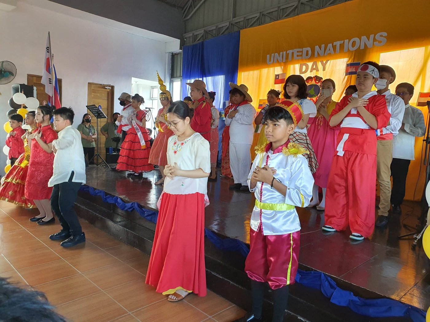 A pupil in costume walking the United Nations Day stage