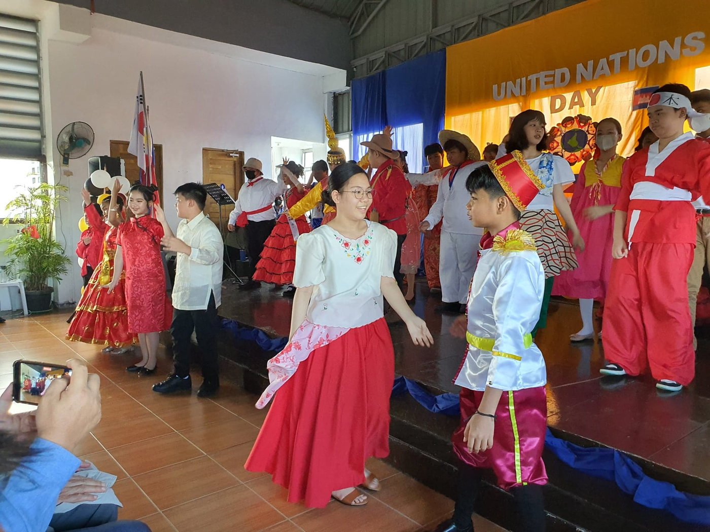 Pupils in red and gold costume performing